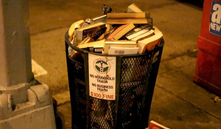 Trash can full of books