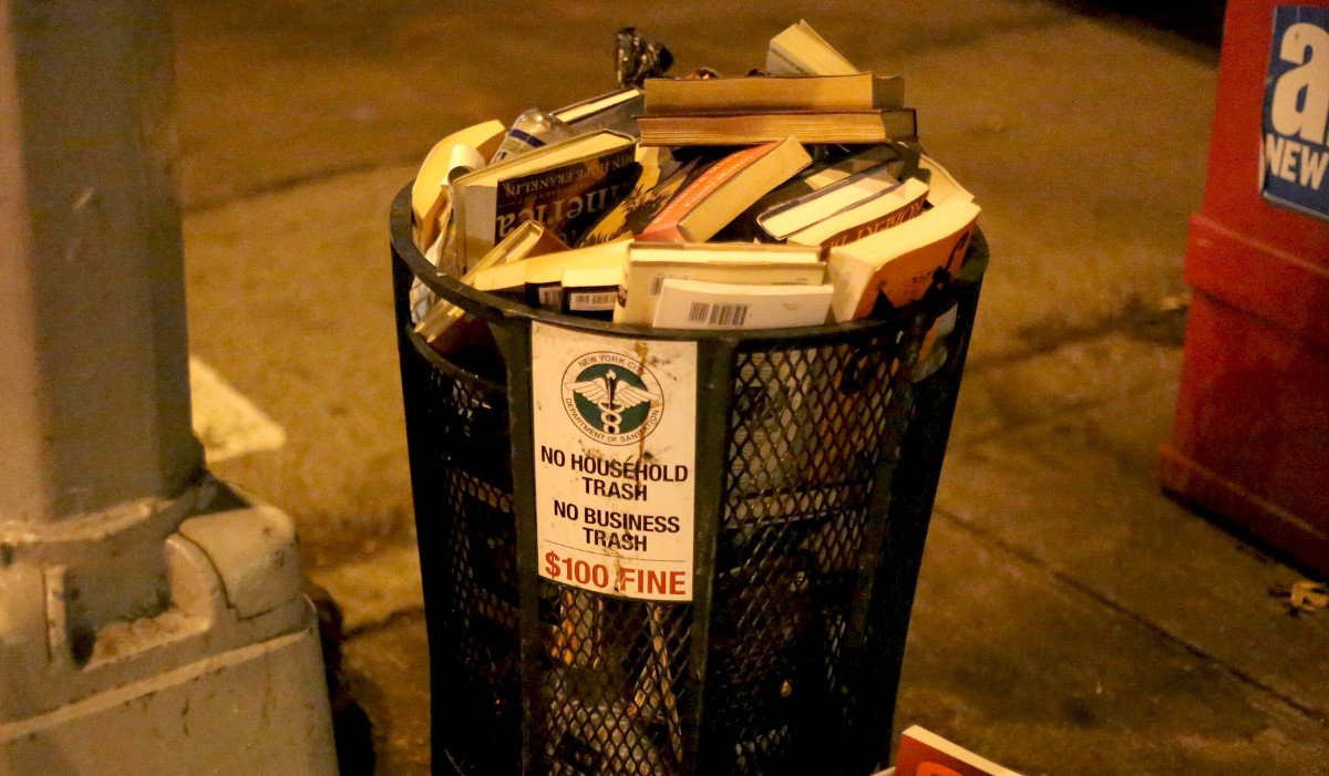 Trash can full of books