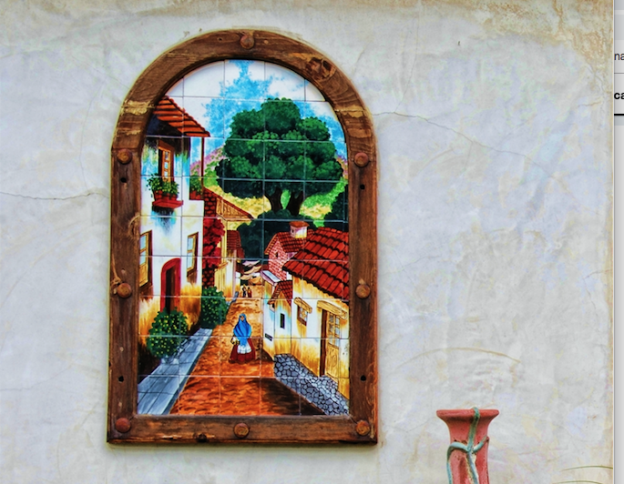 Southwestern-style mosaic showing a street with tiled roofs