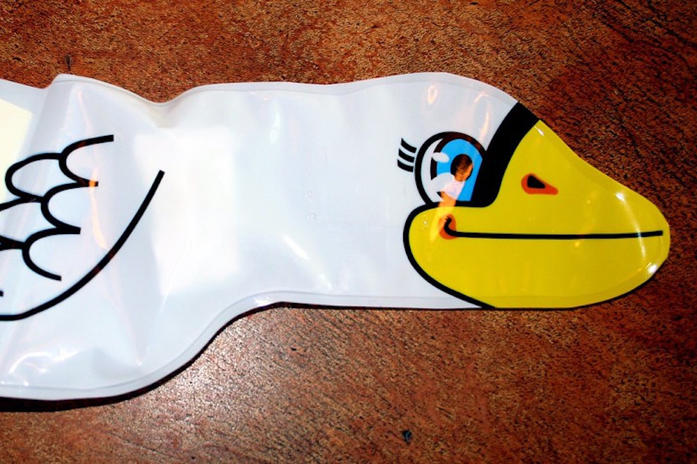 A deflated inflatable swan that is 100% just getting through the day however it can