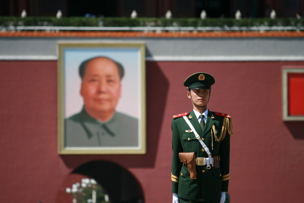 Guard in front a portrait of Chairman Mao in Tiananmen Square