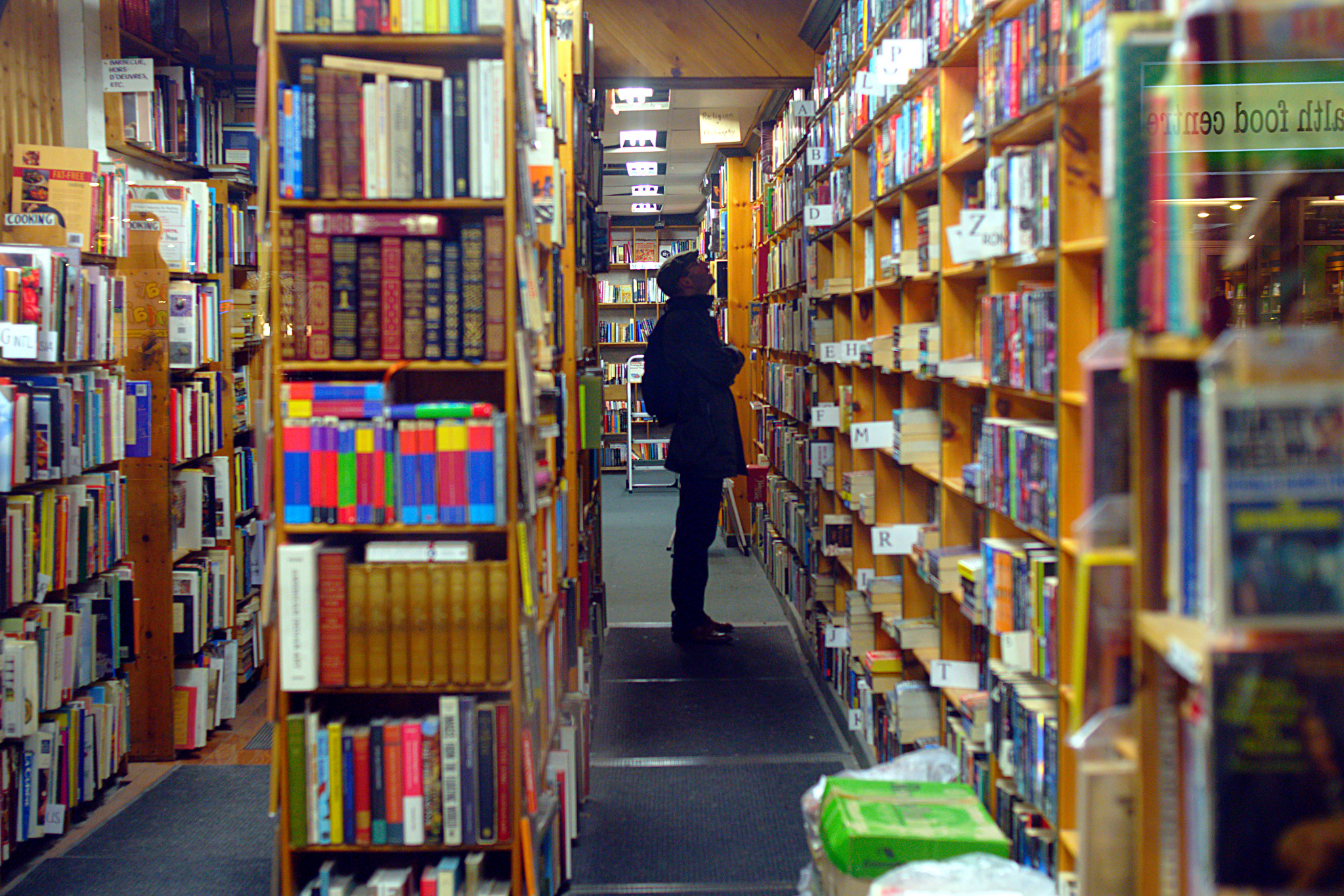 Man looking at the shelves in a bookstore