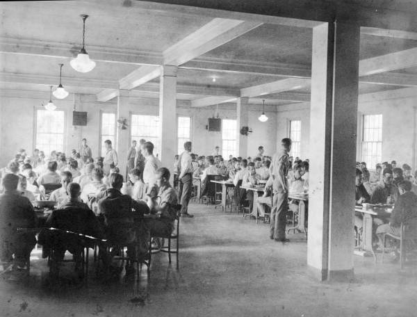 1950s photograph of a crowded institutional cafeteria full of boys