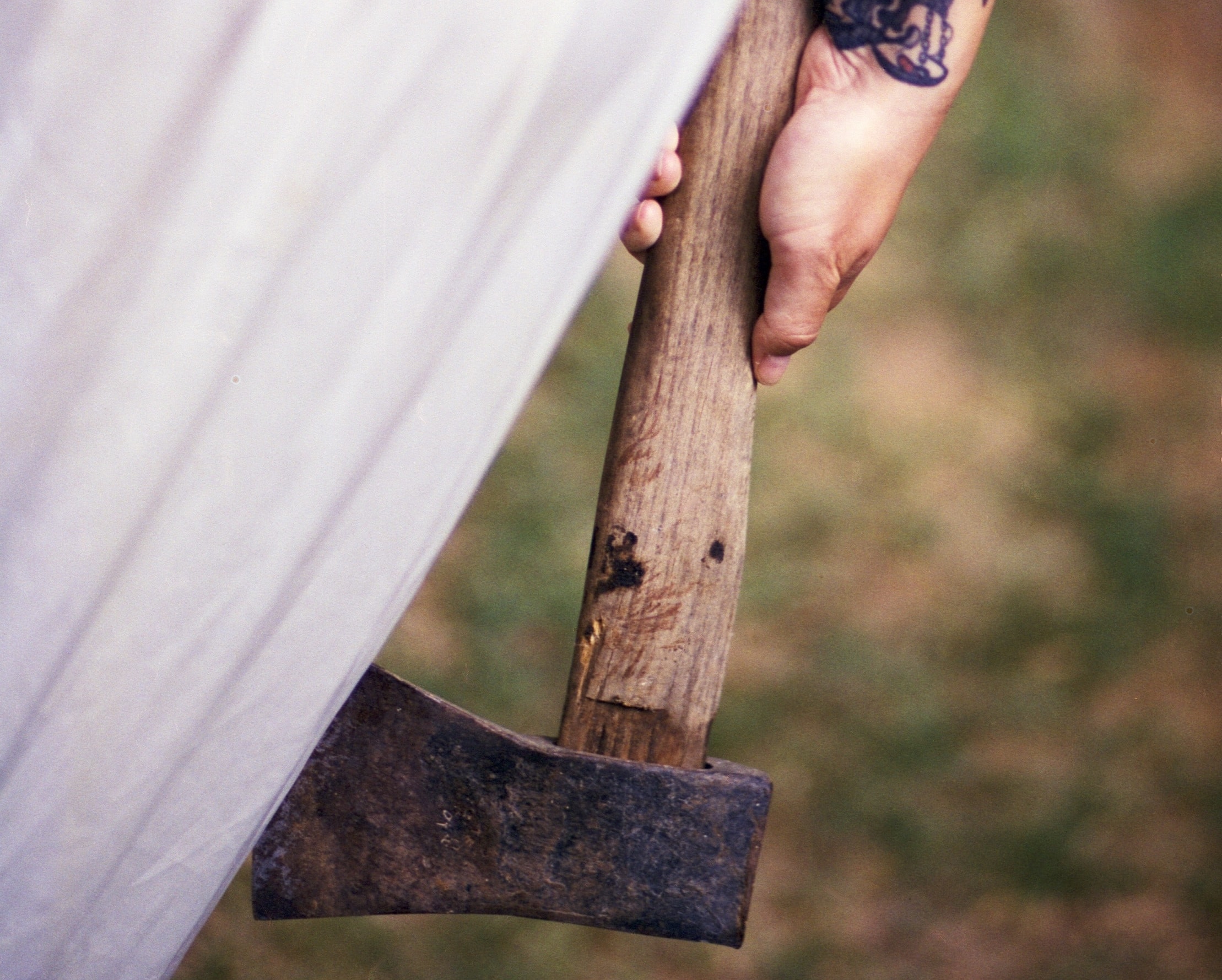 Woman with owl tattoo holding axe