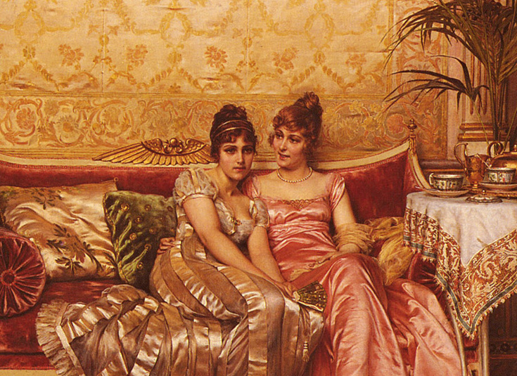Two women gossiping on a couch