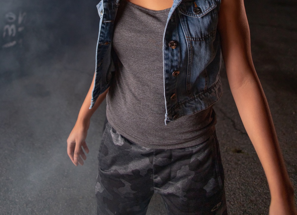 Girl standing on smoke-filled street