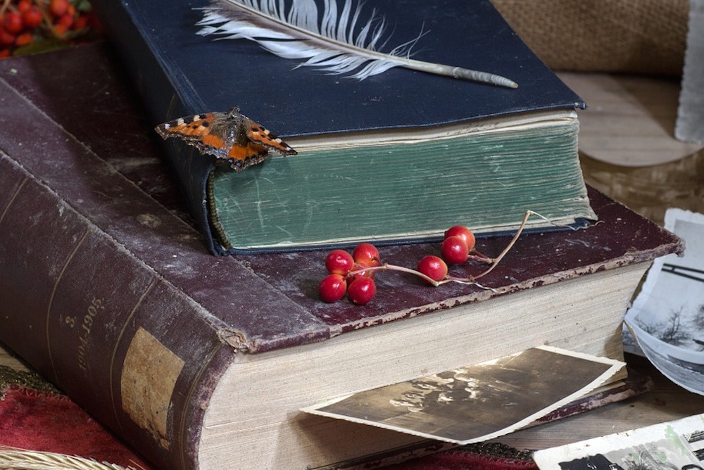 Old books with family photos nearby
