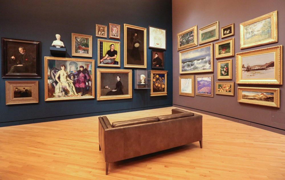 Sofa in front of framed paintings at art museum