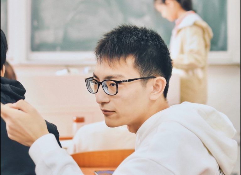 Asian boy in high school classroom