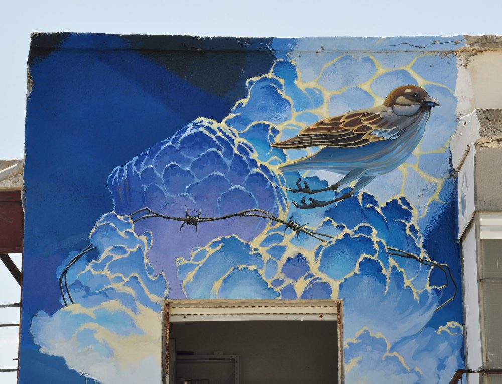 Mural of bird on side of building