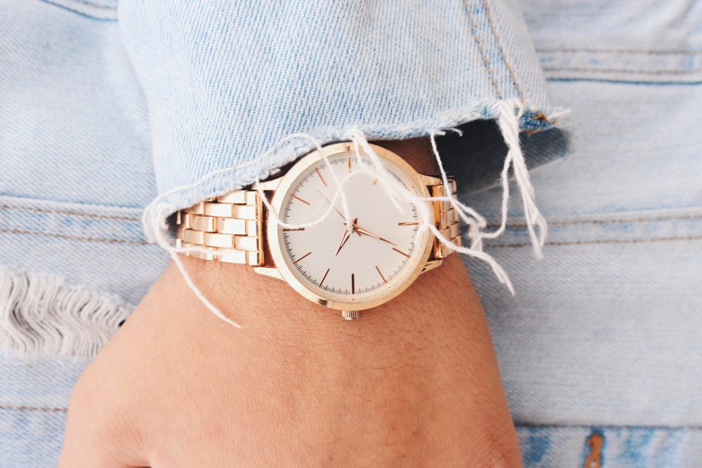 Hand wearing rose gold watch