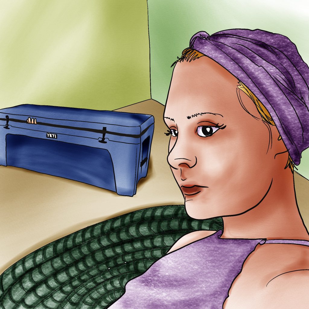 Woman with light skin and blonde hair mostly covered by a purple turban, sitting in front of a large blue Yeti-brand cooler with a few fingers peeking out.