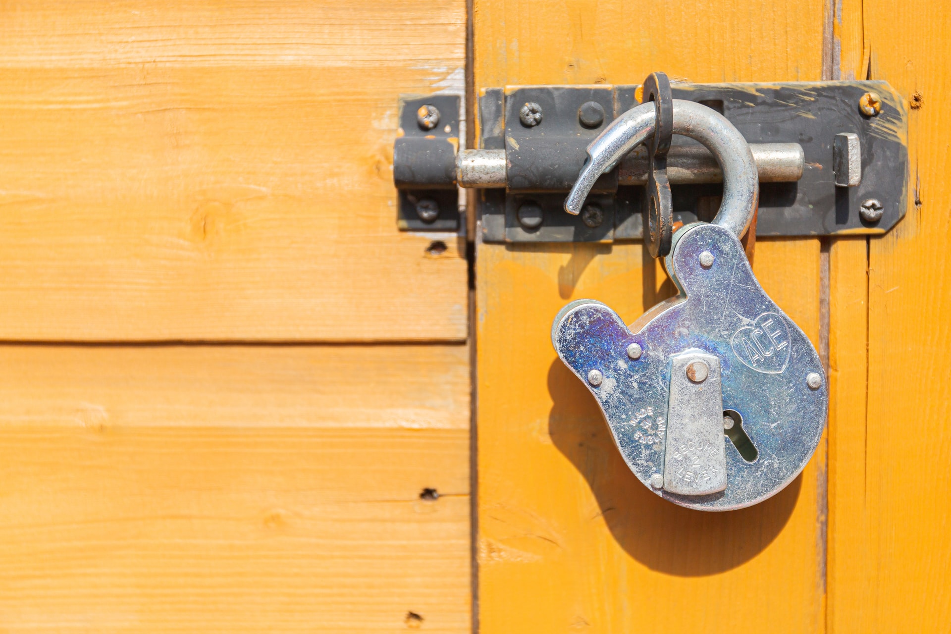 Unlocked padlock on yellow background