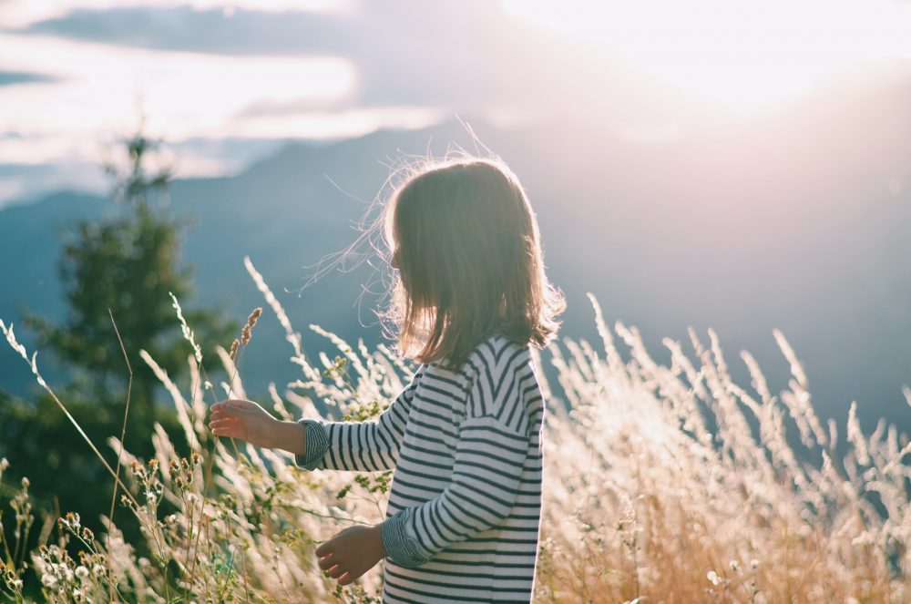 Young girl in brightly lit field