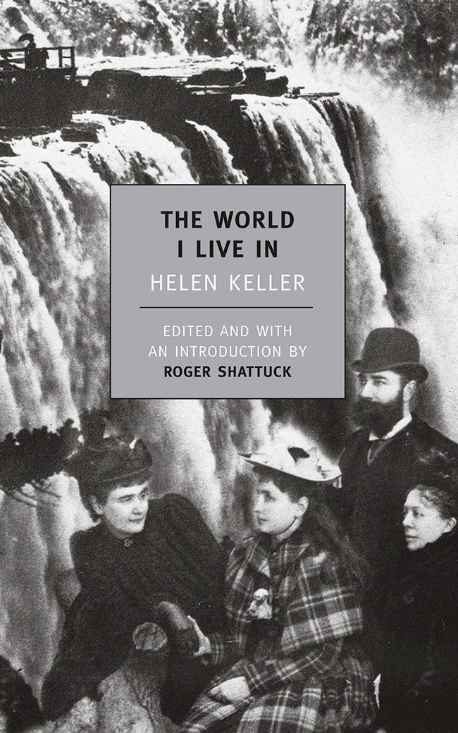 Black and white photograph of Hellen Keller and three other people in front of Niagara Falls. The text reads: The World I Live In by Helen Keller. Edited and with an Introduction by Roger Shattuck
