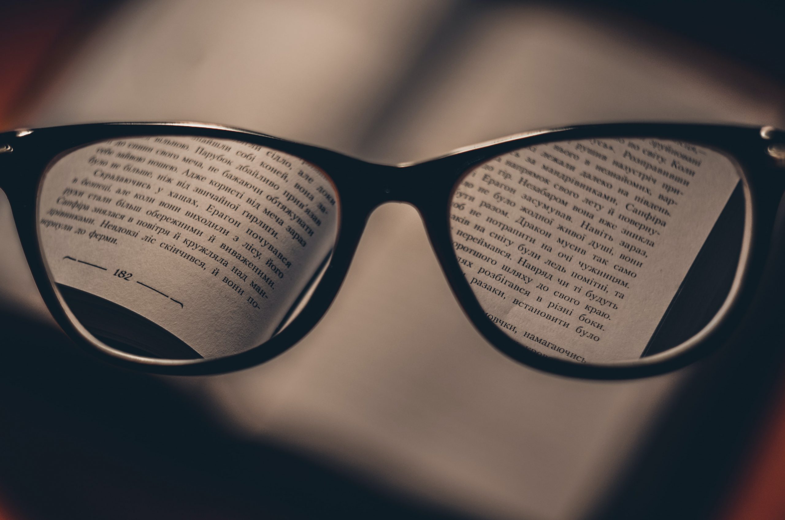 Pair of glasses over a book