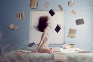 books flying around woman