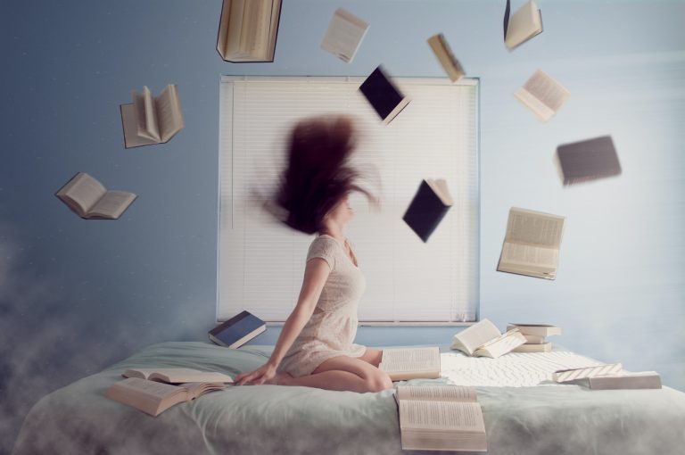 books flying around woman