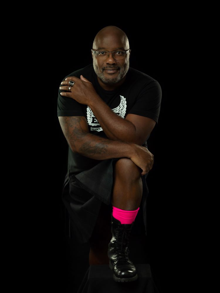 Photo of JUBI ARRIOLA-HEADLEY on dark background