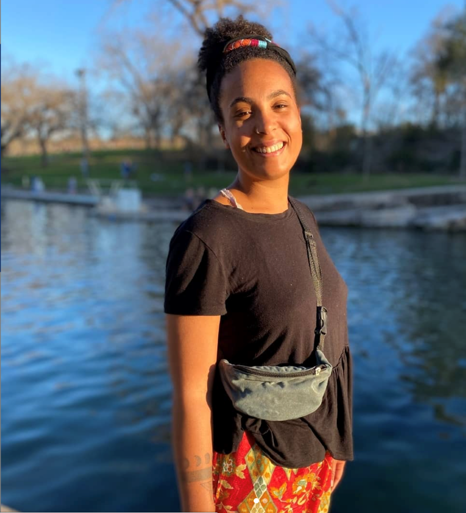 Photo of Coryna Ogunseitan standing in front of a lake