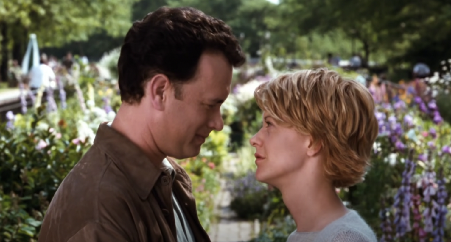 Tom Hanks and Meg Ryan looking at each other in still from the film "You've Got Mail."