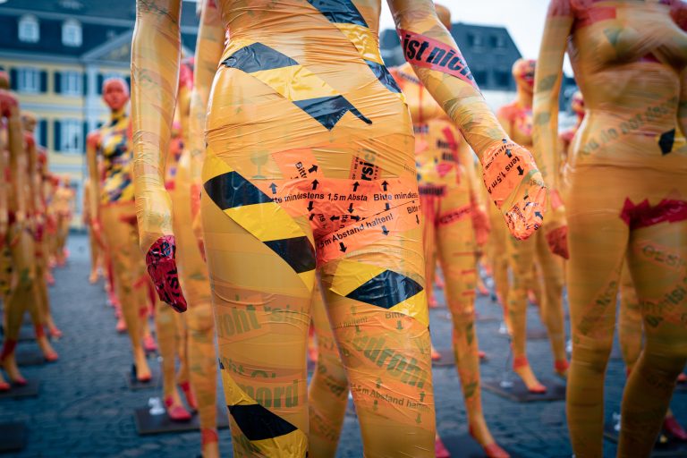 A mannquein's waist covered in caution tape.