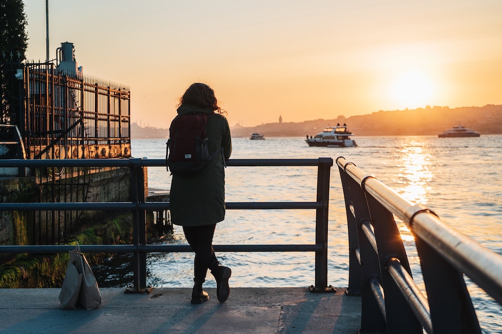 A woman staring into the sunset in Istanbul