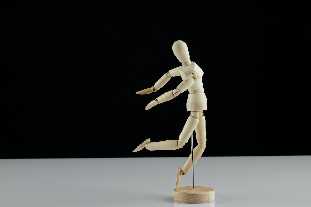 Wooden drawing model taking a leap