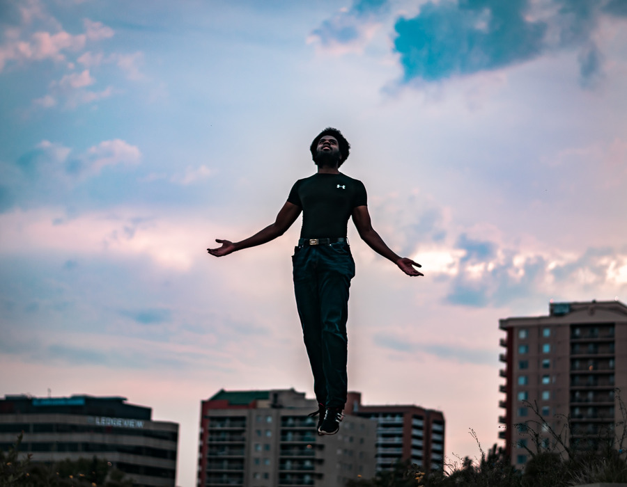 A man floats above skyscrapers