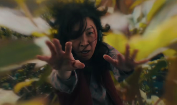 Evelyn from "Everything Everywhere All at Once" travels through time with her arms outstretched