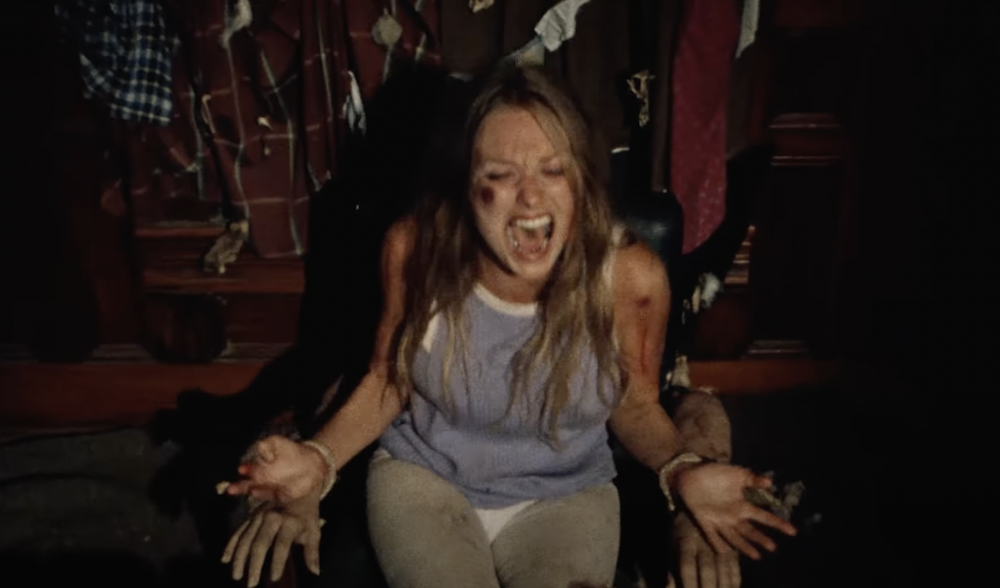 A woman screaming with blood on her body