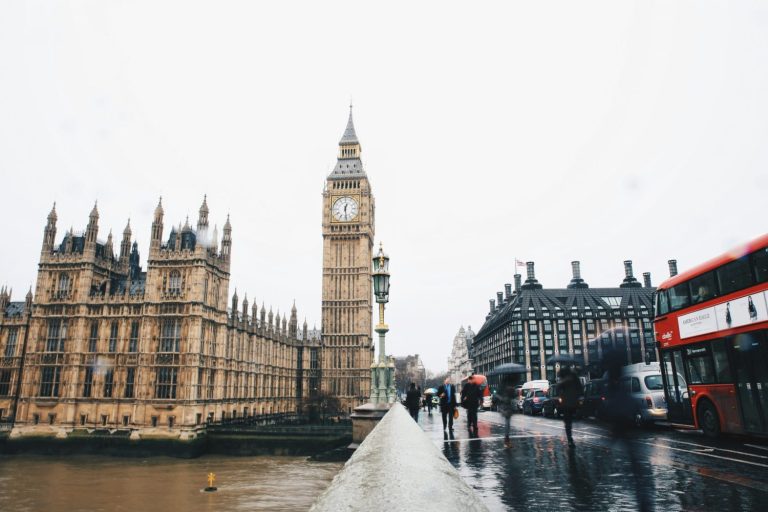 Big Ben clocktower with red bus in the background