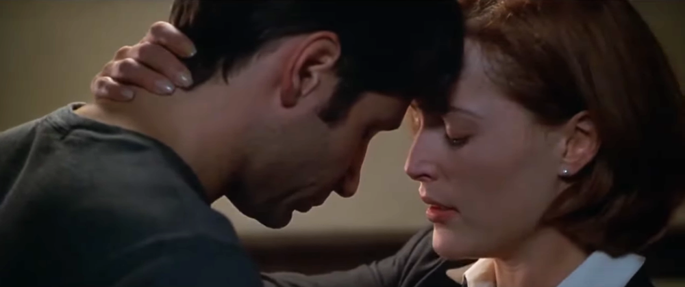 Mulder and Scully from "The X-Files" locked in an embrace