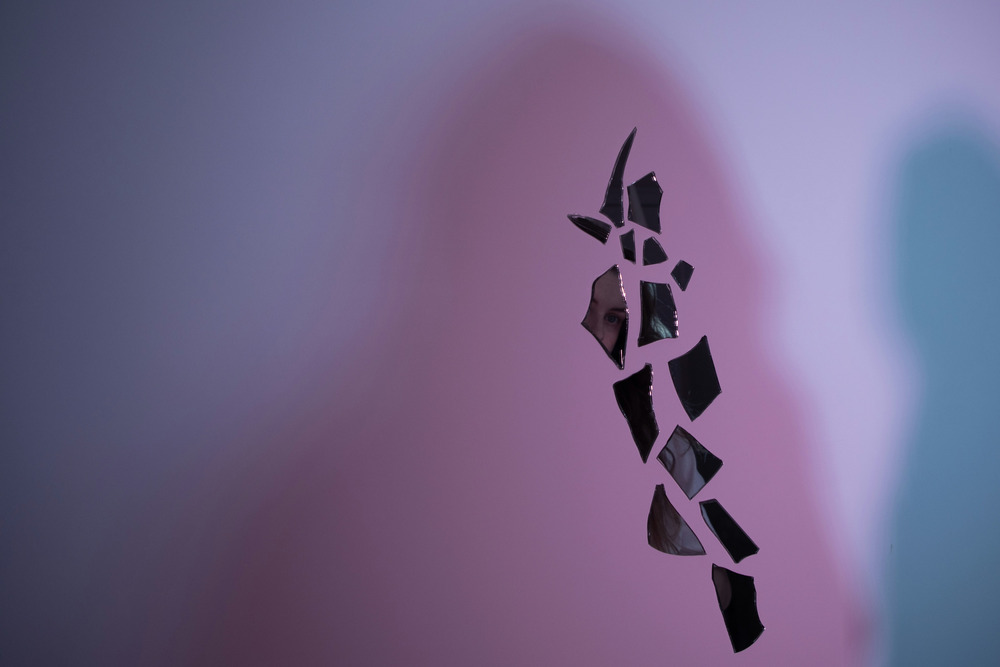 Fragments of a broken smart phone floating in the air